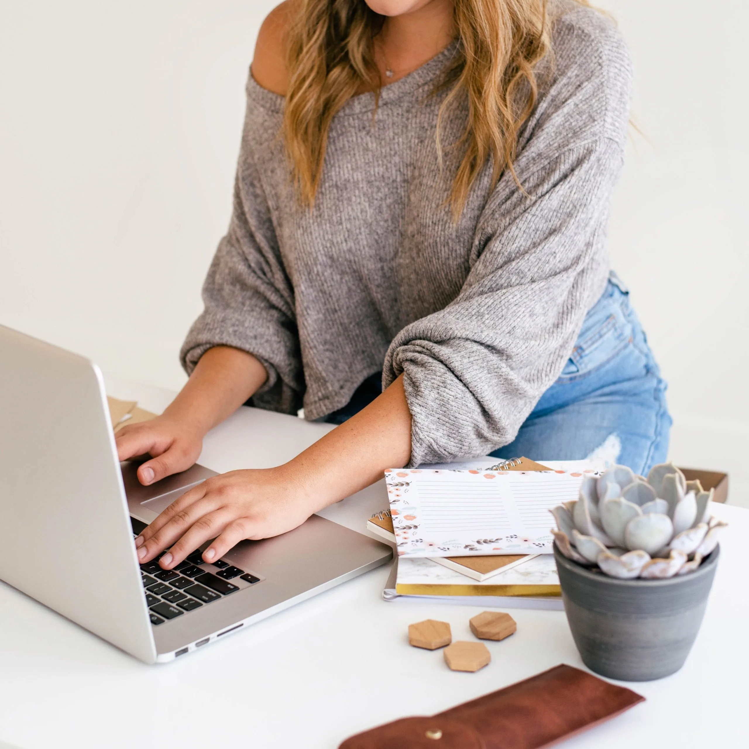 Female typing on MacBook
