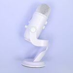 white blue yeti microphone on a mauve background