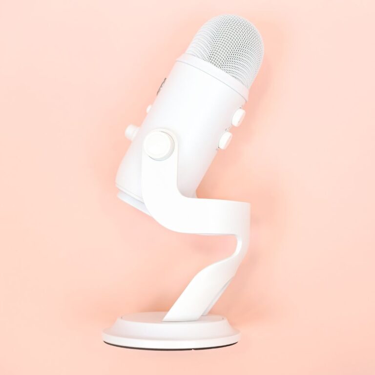 white blue yeti microphone on a peach background
