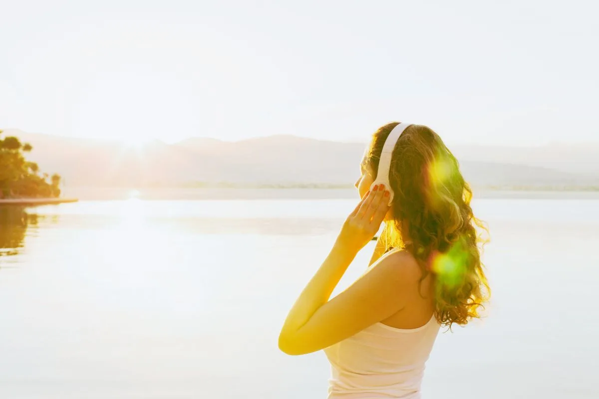 Girl listening to a podcast on headphones outside