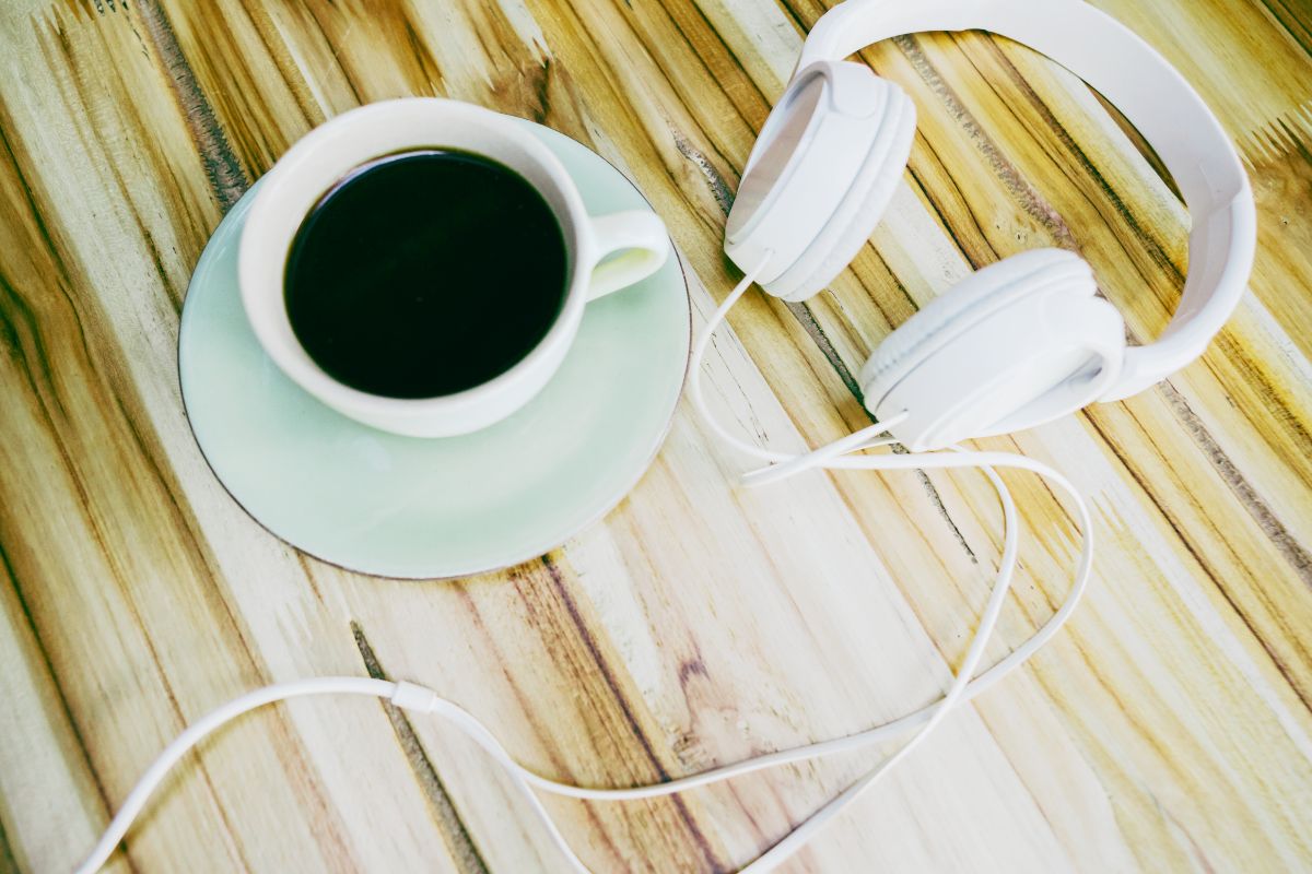 Coffee cup and headphones on a table