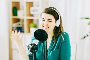 Girl in green shirt recording her podcast episode