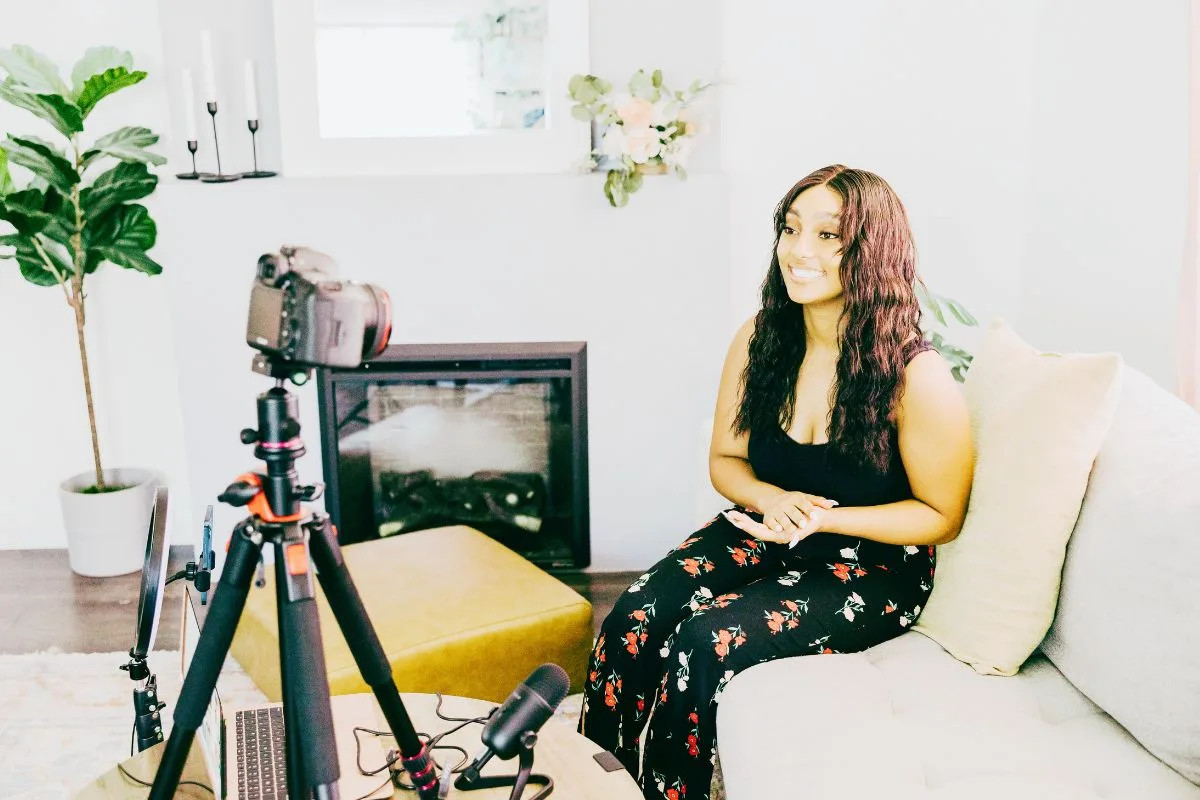 Girl recording YouTube video sat on sofa