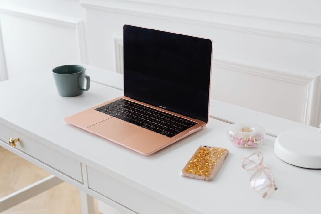 pink laptop on desk