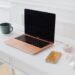 pink laptop on desk