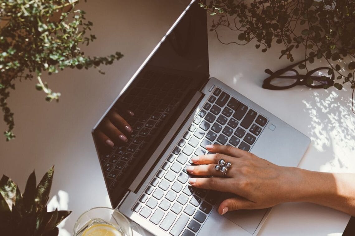 female hand typing on a laptop