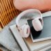 pink headphones on a stack of books on a chair